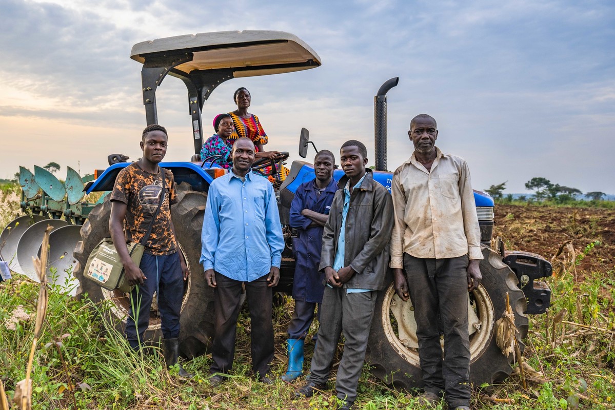 Farmers in Uganda coffee farmers in Uganda in front of their tractor